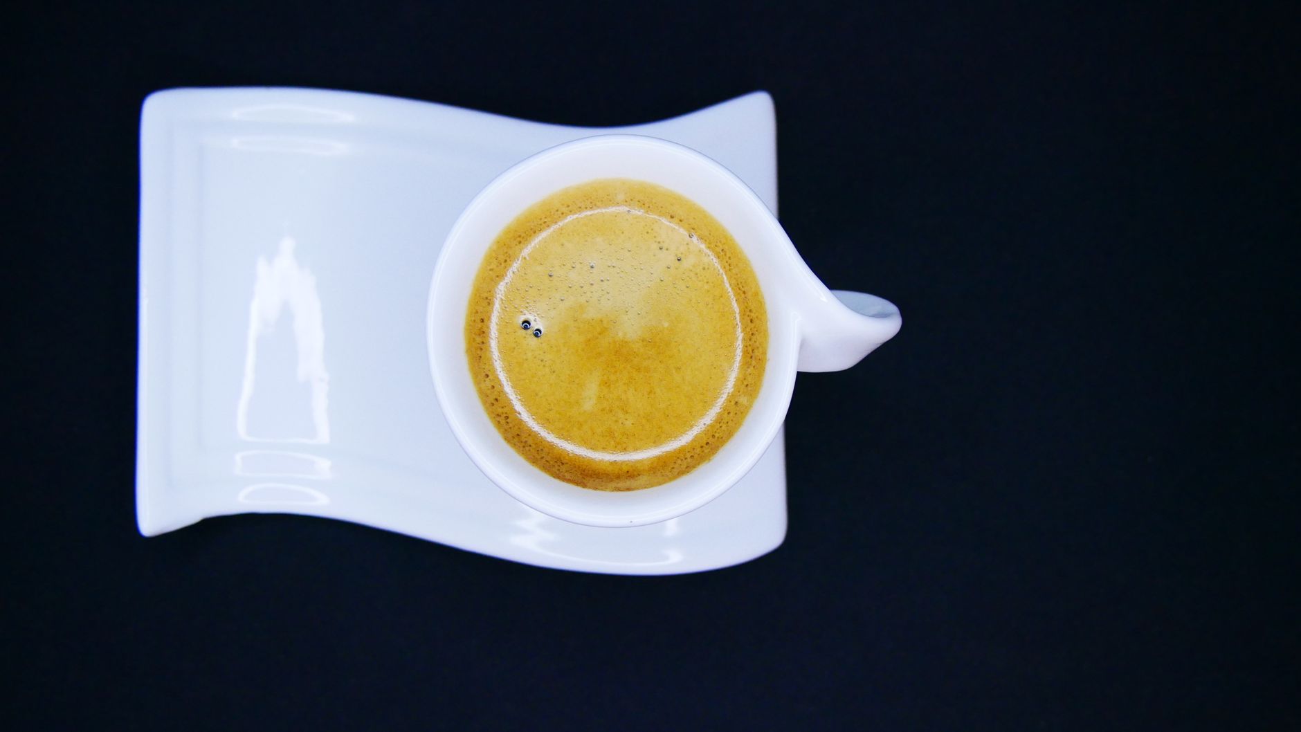 espresso shot golden crema in demitasse cup