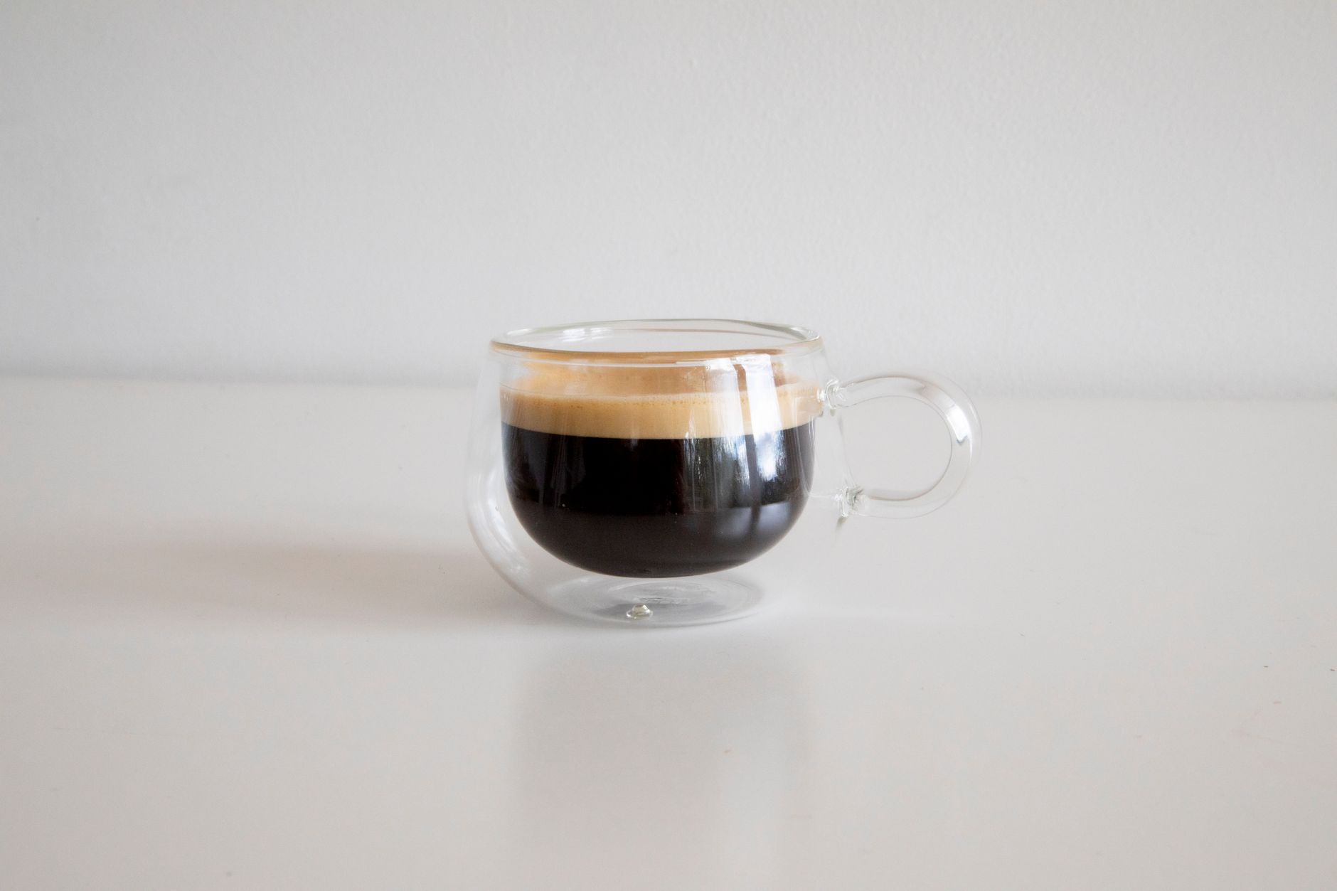 double espresso shot poured over ice glass