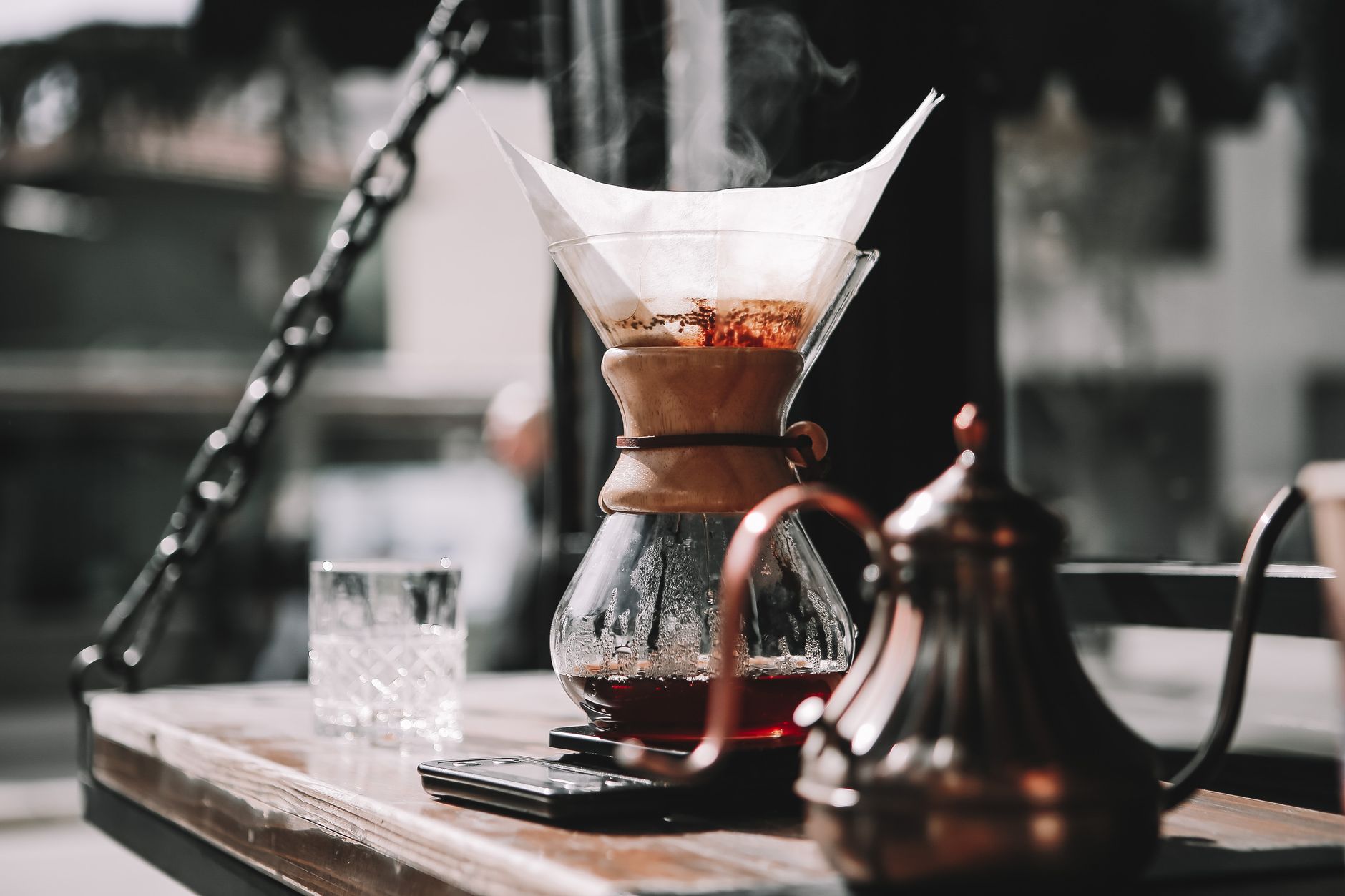 three pour over brewers side by side on wooden counter